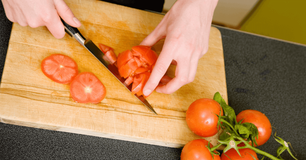 Chopping diced tomatoes to put in the freezer