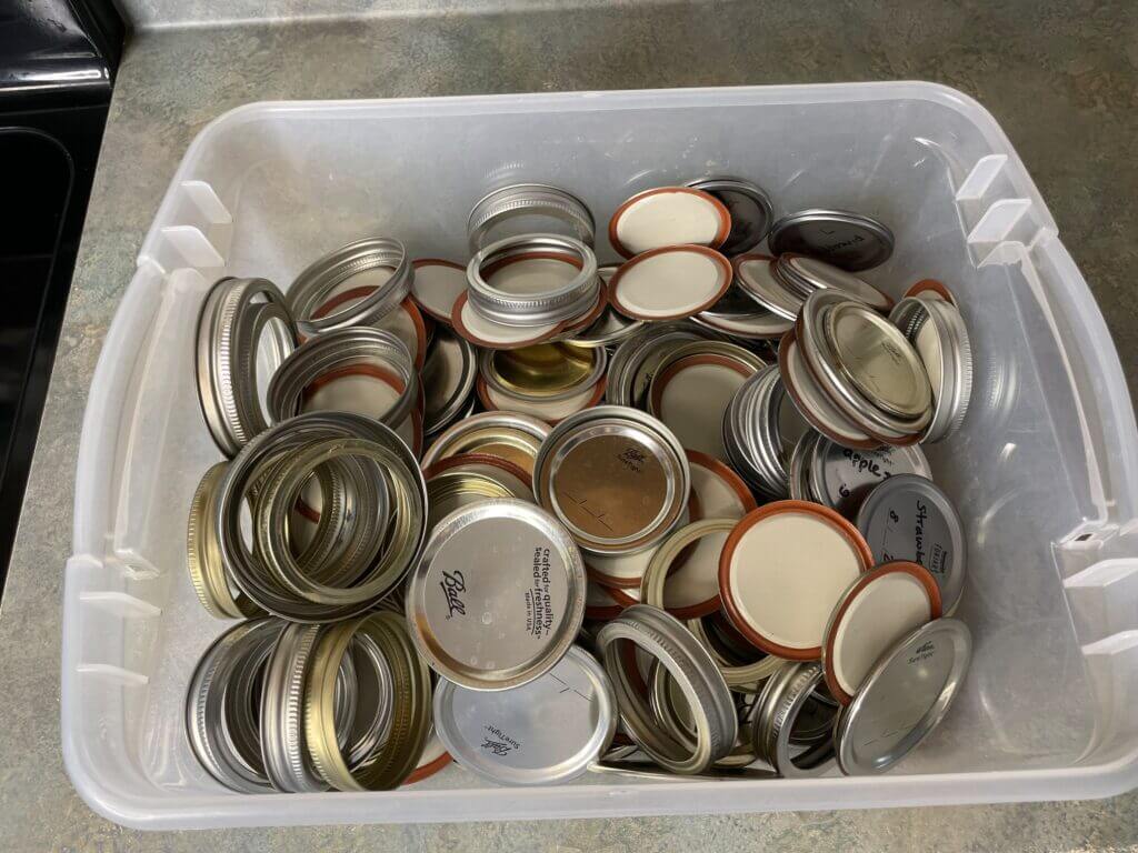 A box of old canning lids to be reused.